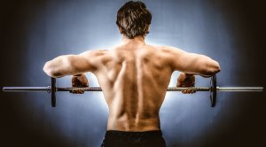 Man working out his shoulders with upright rows exercise