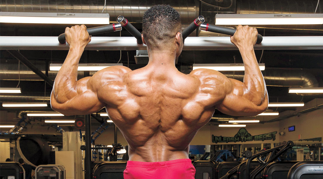Professional bodybuilder Henry Pierre Ano doing a back workout using a V-Bar pullup lat exercise