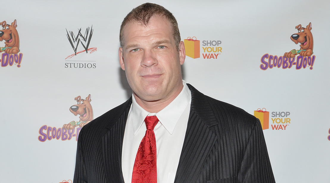 WWE Wrestler Kane Poses On The Red Carpet In A Suit And Tie. 