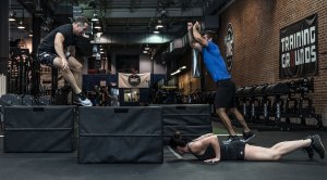 Crossfit class performing various EMOM workout at a crossfit gym