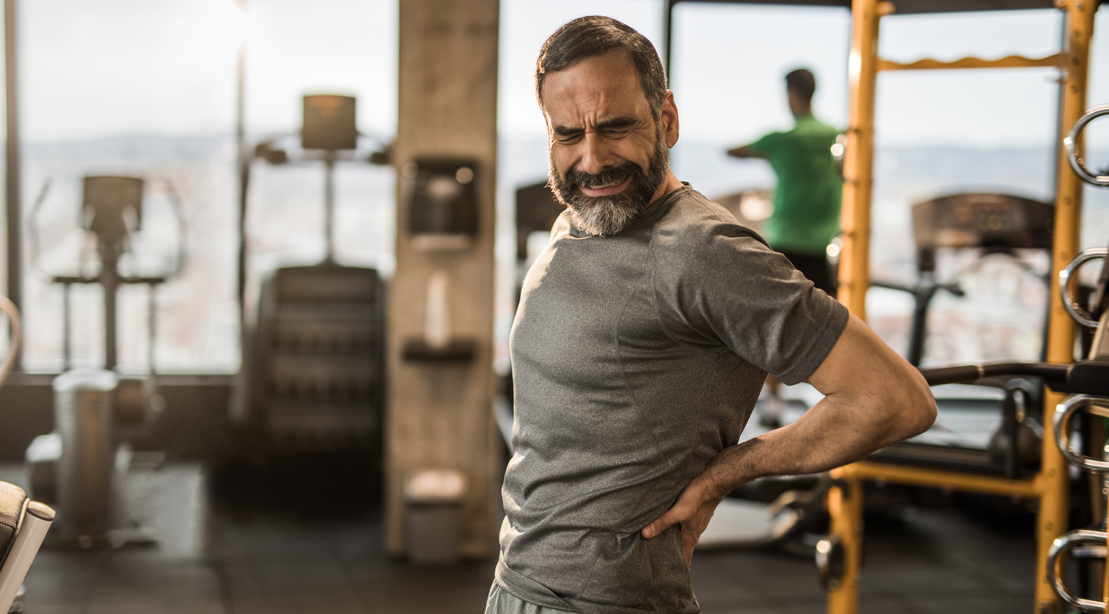 Old man suffering from back pain from post exercise muscle soreness
