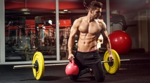 Man performing kneeling exercises with a kettlebell for a strength workout