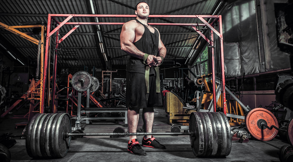 Bodybuilder-Big-Man-Preparing-For-Deadlift-Wrist-Straps-Barbell