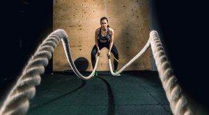 Female Doing Battle Rope exercises at end of ropes