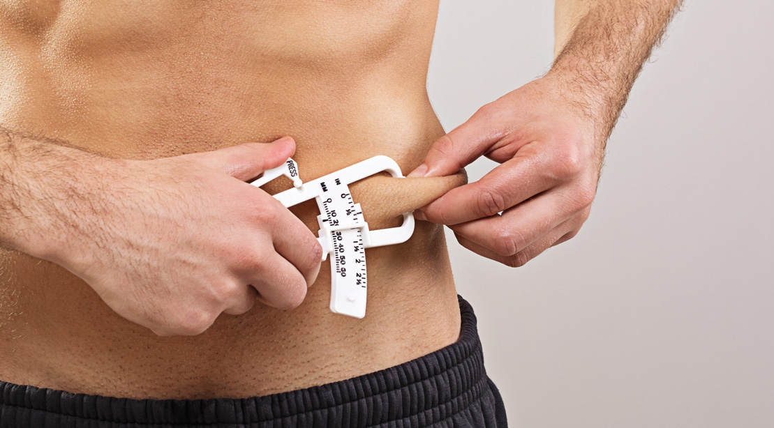Man Measuring Body Fat With Caliper