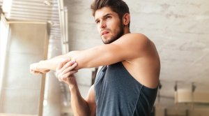 Man-Stretching-Arm-In-Sunny-Room to boost your mental health