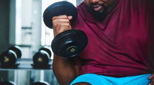 Overweight-Man-Lifting-Lightweight-Dumbbell