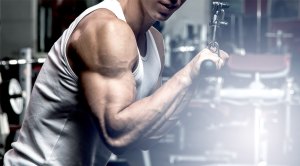 man with muscular arms doing tricep exercises and workouts