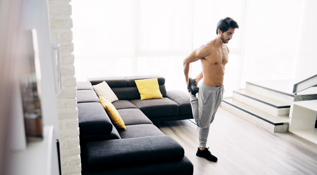 Man-Stretching-Quads-In-Home-Living-Room