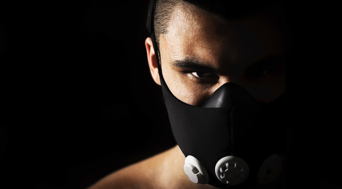 Focused man wearing a high altitude training mask