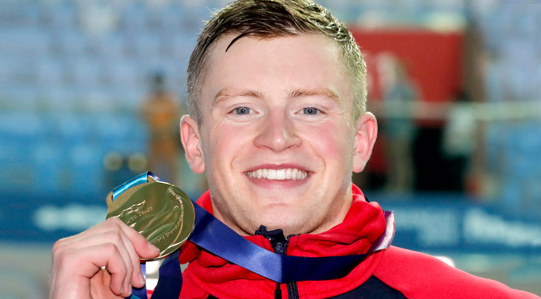 2016 Olympic gold medal breaststroke swimmer winner Adam Peaty holding his medal
