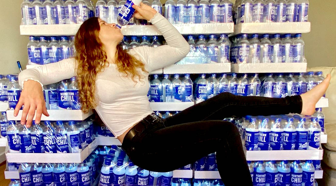 Female UFC fighter Miranda Maverick drinking a bottle of Northern Chill Water