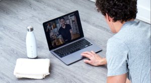 Man doing an at-home workout during covid pandemic using the Flexit App on his laptop