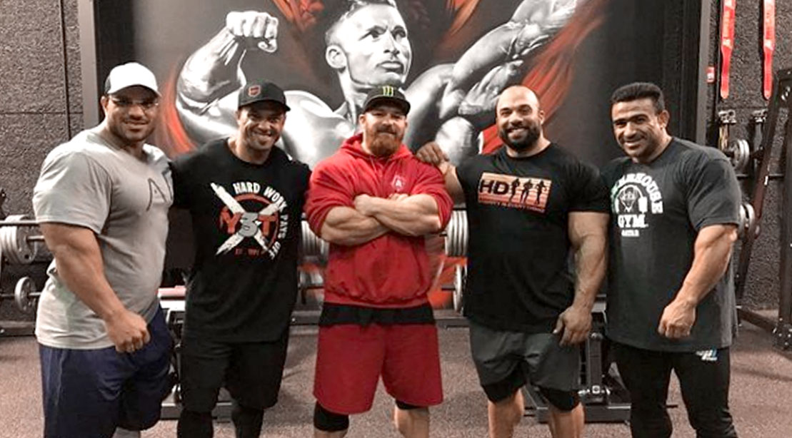 Bodybuilder Flex Lews "The Welsh Dragon" standing with other bodybuilders in his new gym in Las Vegas "The Dragon's Lair"