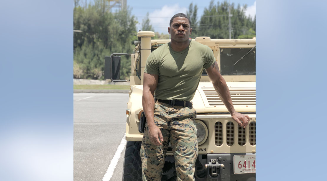 Aaron Marks standing next to a humvee ready for his 1000-reps workout