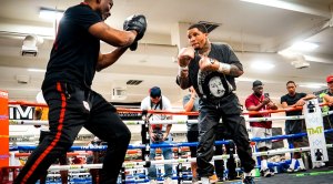 Boxing champ Gervonta Davis training in a boxing gym with his boxing trainer