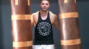 Chris Evangelou holding two heavy bags to perform his heavy bag drills to improve his boxing technique