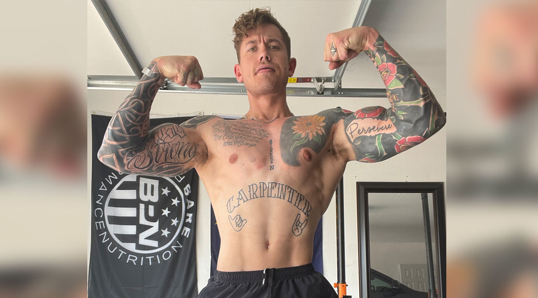 Logan Carpenter flexing his muscles for his “Chest Destruction” Workout