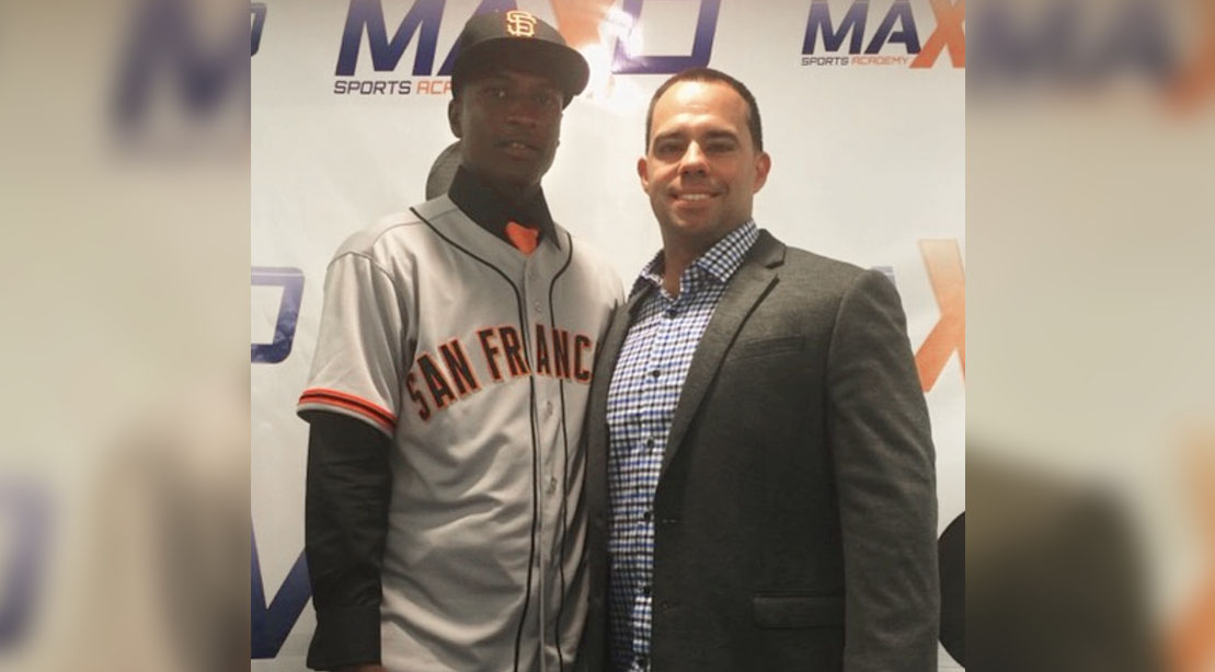 Major League Baseball agent Roger Tomas standing with San Francisco Giant Lucius Fox