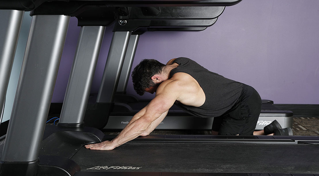 Man performing the treadmill press exercise for his arm workout