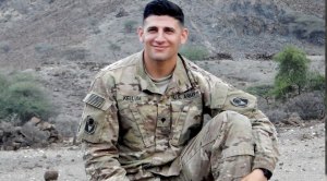 Army and Military soldier Chris Kellum posing in the mountain for his Shoulder Domination Workout Routine