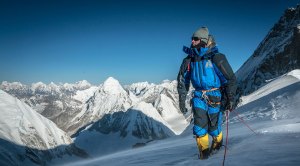 Climber Adrian Ballinger climbing the summit of a snowy mountain range