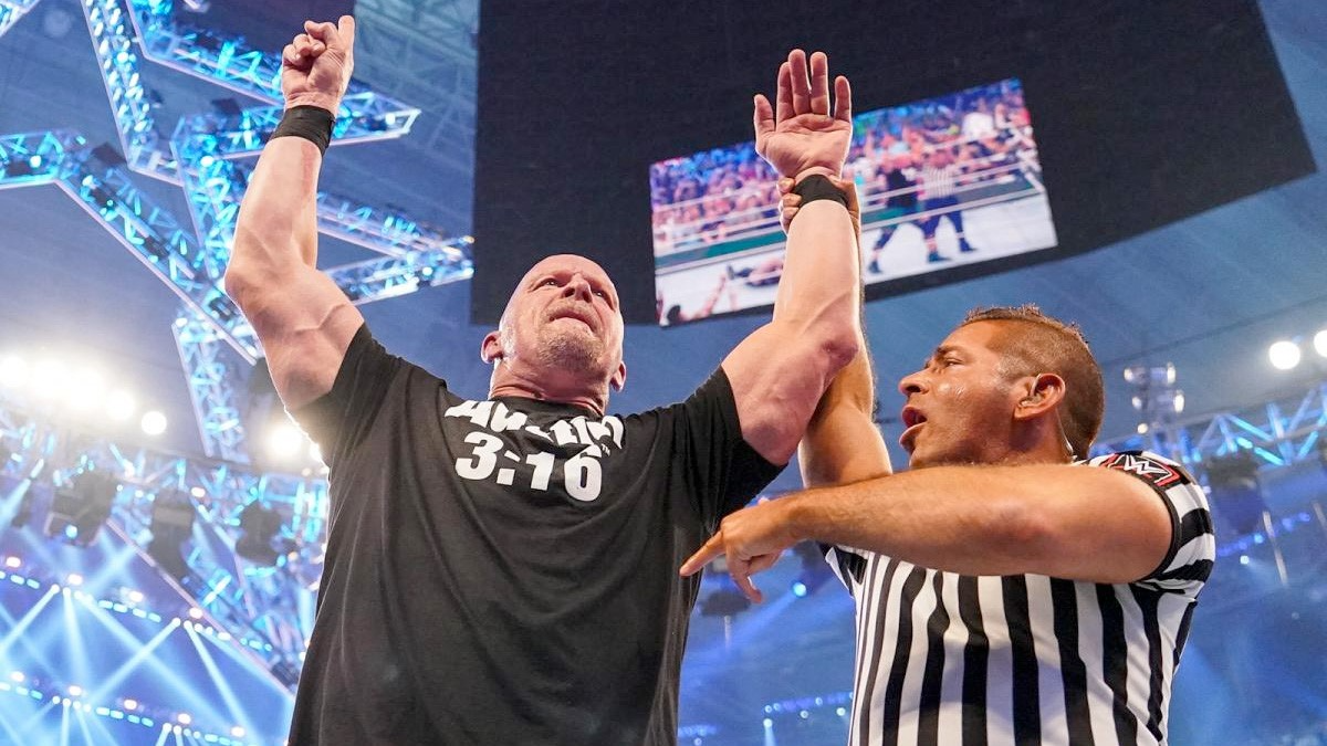 Stone cold steve austin being haled the champion at WrestleMania 38