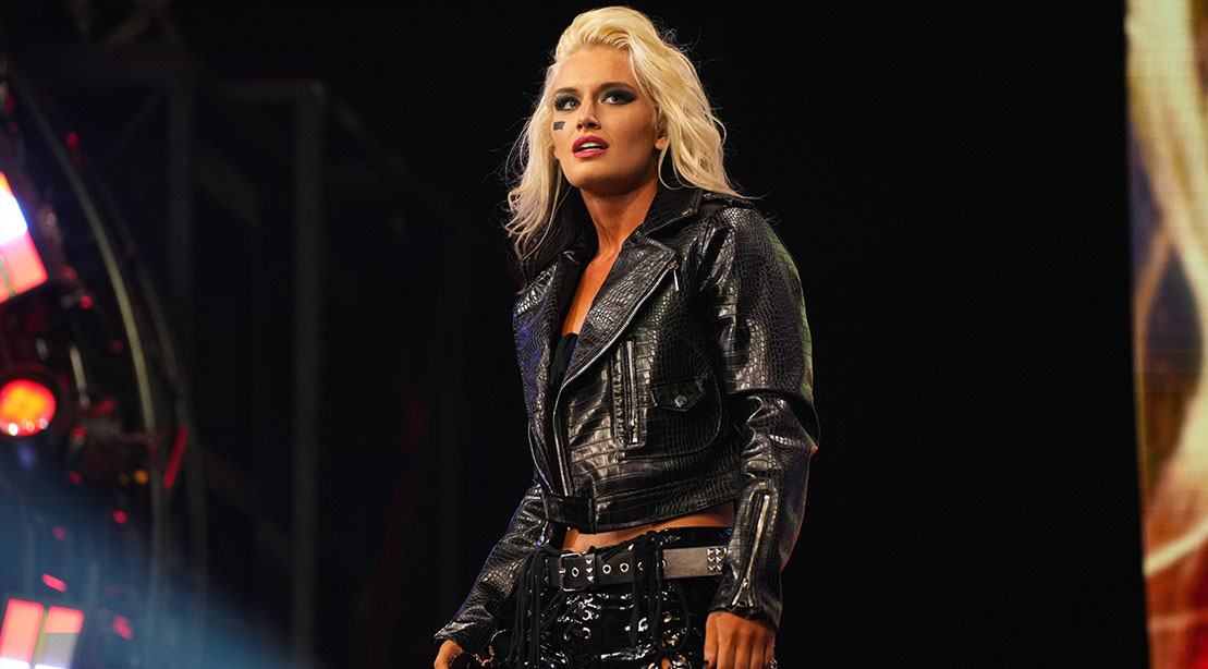 Female wrestler Toni Storm wearing a black leather jacket and pants
