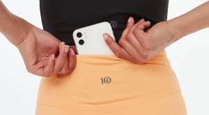 Women putting her iphone in the back of her tentree dress