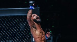 MMA fighter Demetrious Johnson celebrating a victory in One Championship fight