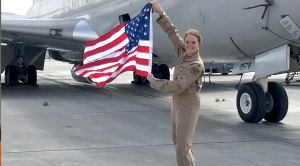 Major Regan Stiegmann holding the american flag
