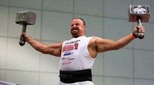 Arm wrestler holding two thors hammers.