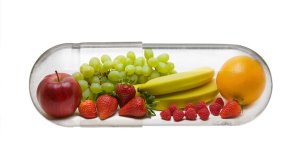 Vegetables and fruits inside a vitamins pill capsule