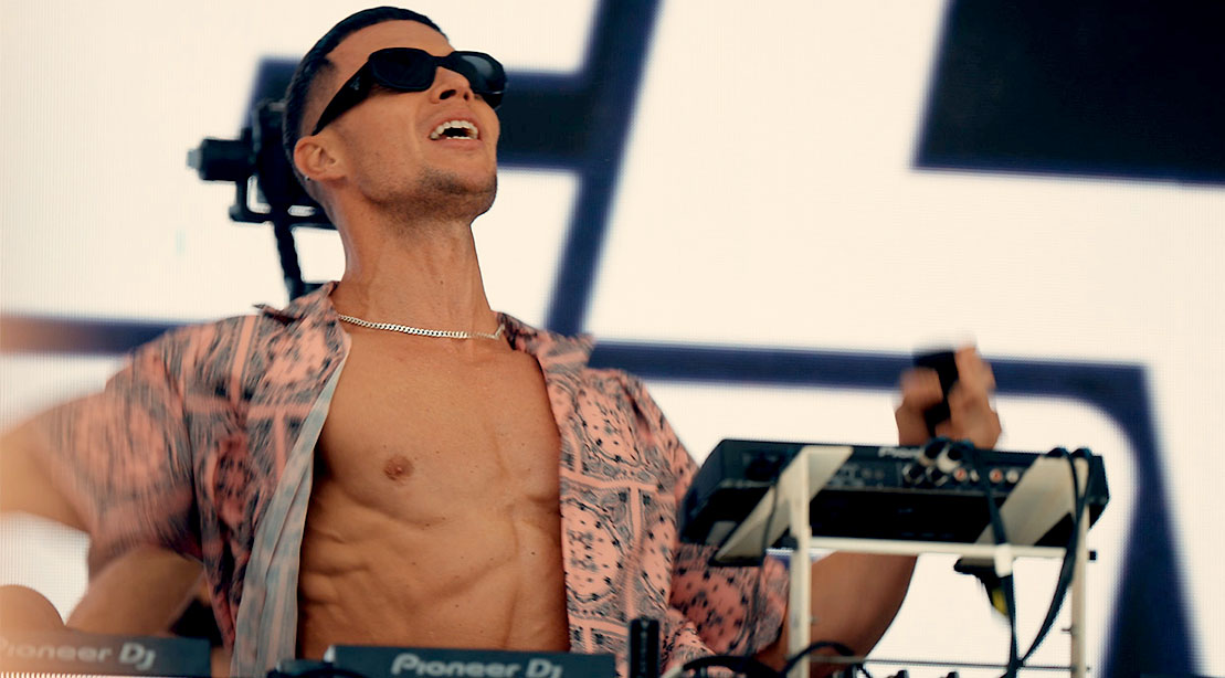 DJ Joel Corry spinning his records at a festival