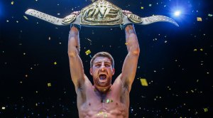 Jonathan Haggerty holding up the ONE Bantamweight Muay Thai World Championship Belt