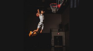 Basketball player going in for a slamdunk after performing the workout for basketball players