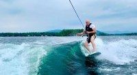 Captain J. Russell Linderman wake boarding on a lake