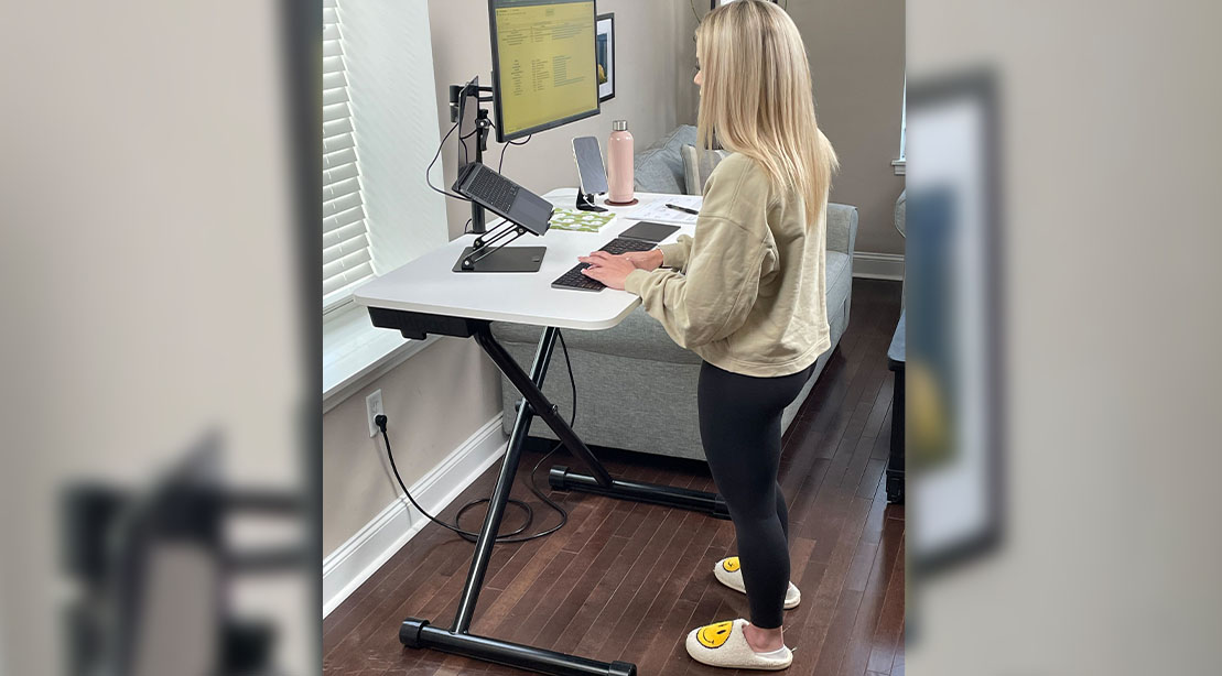 Female working from home while using a Lillipad Standing Desk